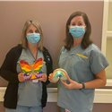 Julie, RN & Stephanie, RN pose with a butterfly an