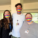 Three members of the HPHA team wearing rainbow fac