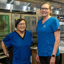 Two Nutrition and Food Services Team Members pose
